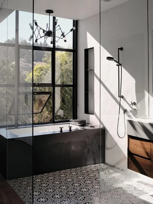 Walk-in glass shower with black fixtures in a Vancouver bathroom