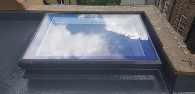 Flat roof skylight reflecting the sky on a Vancouver home