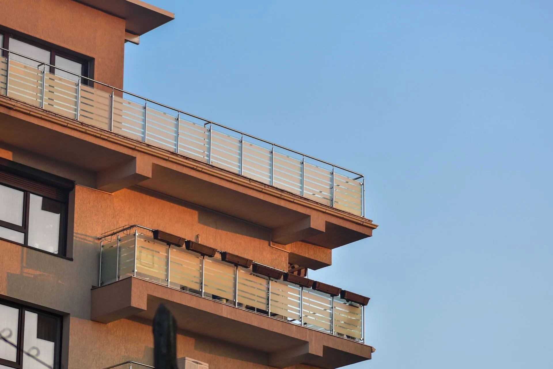 Glass balcony railings on a modern residential building in Vancouver BC