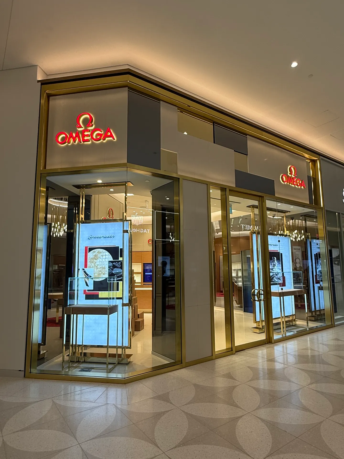 Luxury retail storefront glass with gold framing in a Vancouver shopping mall